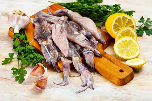 Cooking ingredients, fresh raw calamari on wooden table